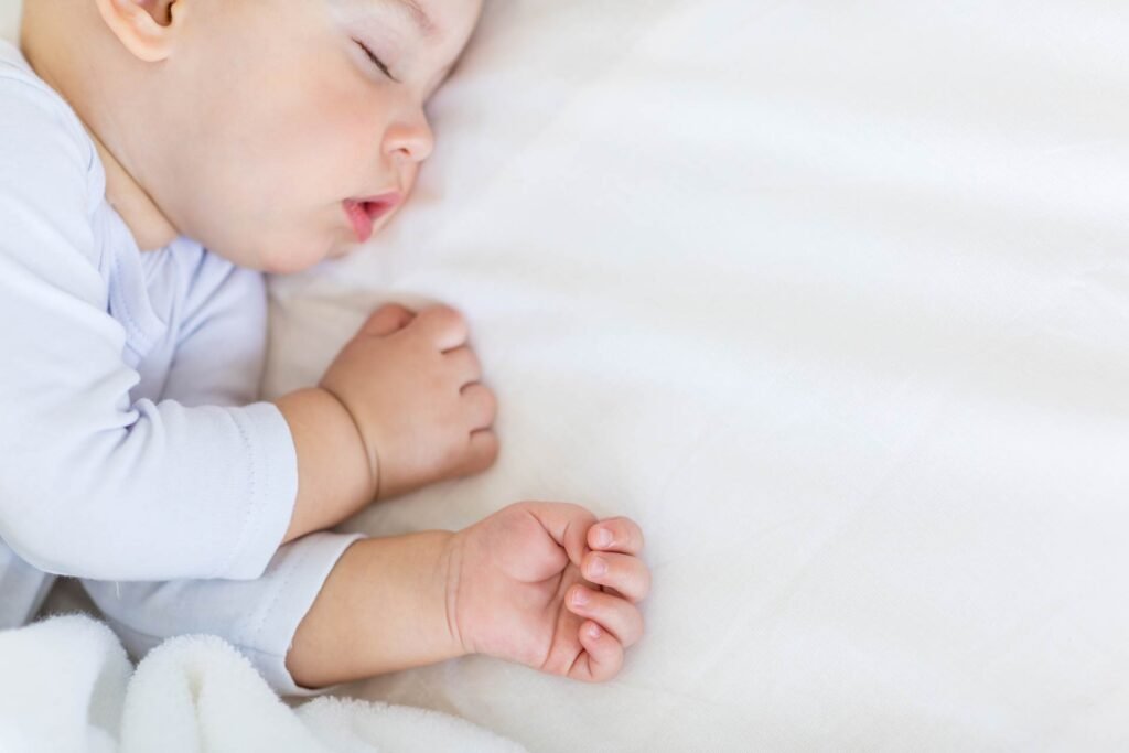 image of a baby sleeping on its side, Trouble Shooting Call for sleep consultation